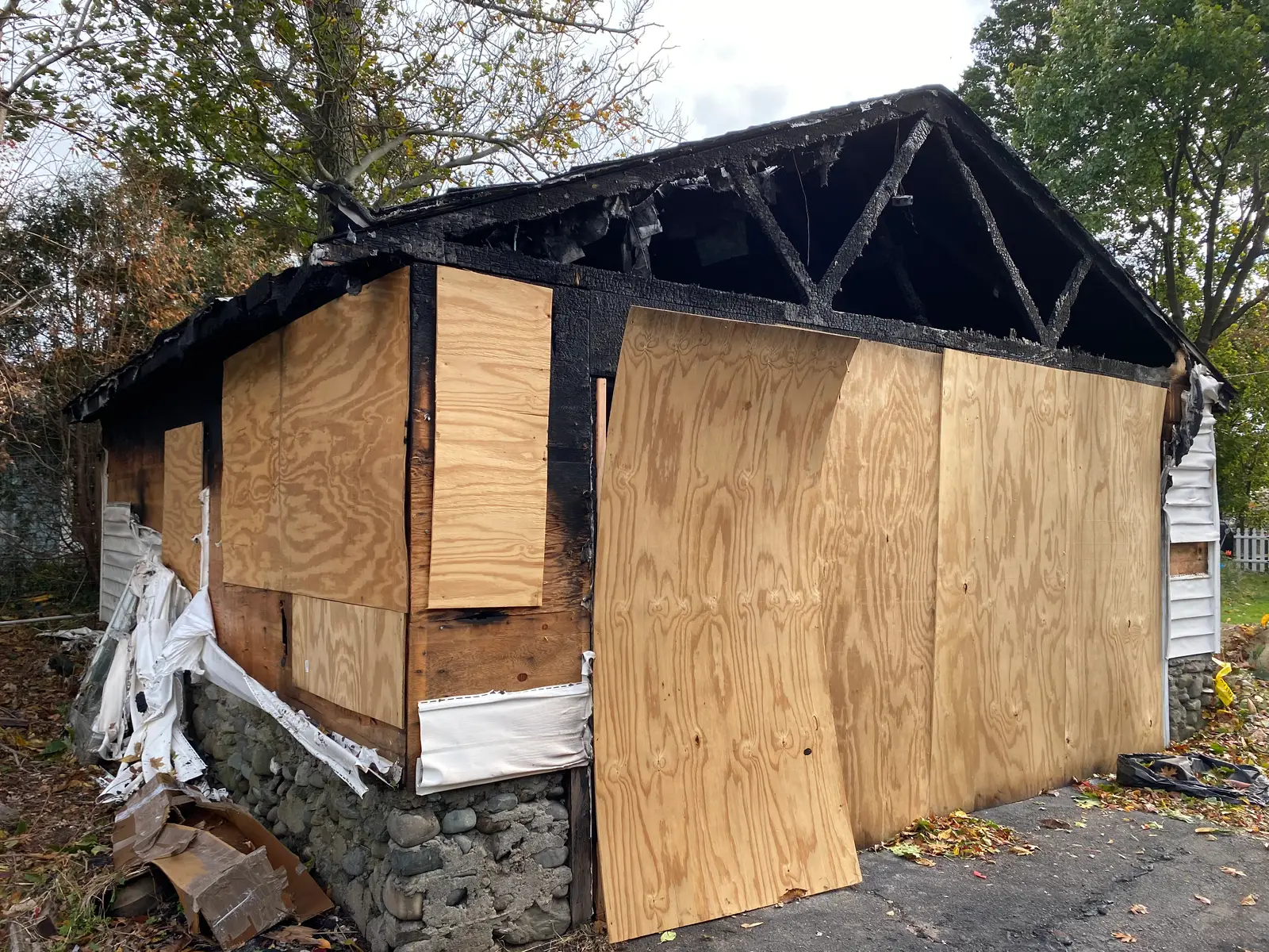 Fire-damaged garage boarded and secured prior to demolition