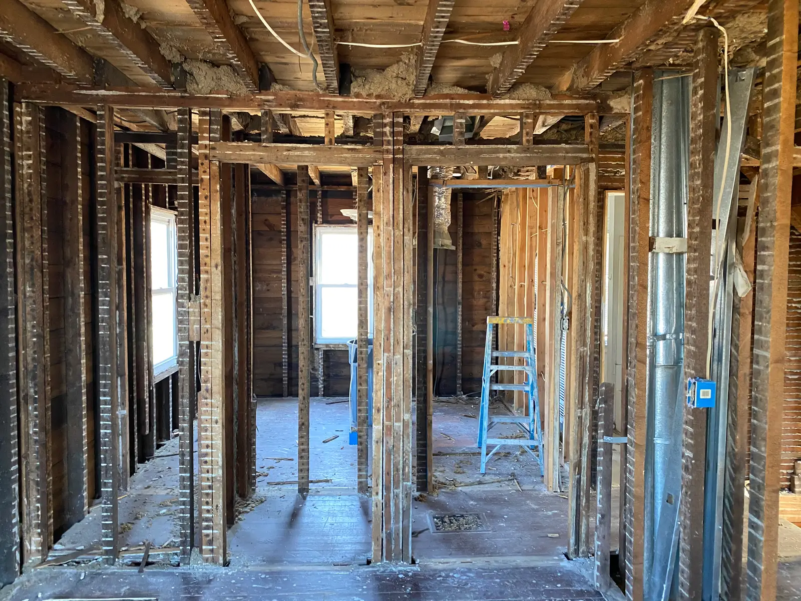 Whole floor gutted to the studs by PRC Demolition — original framing exposed, site swept clean