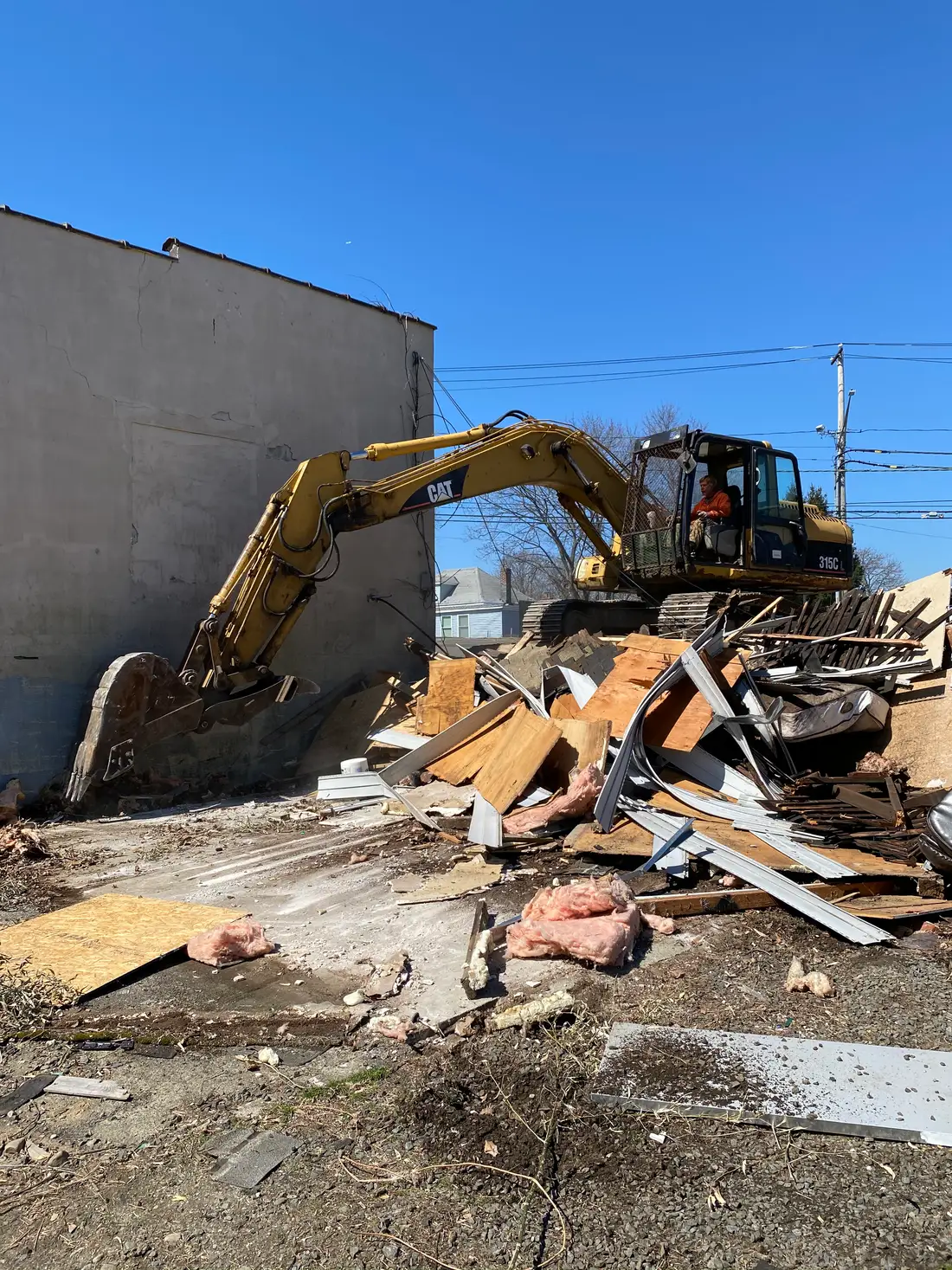 Selective demolition alongside a standing wall on a Milford CT job site